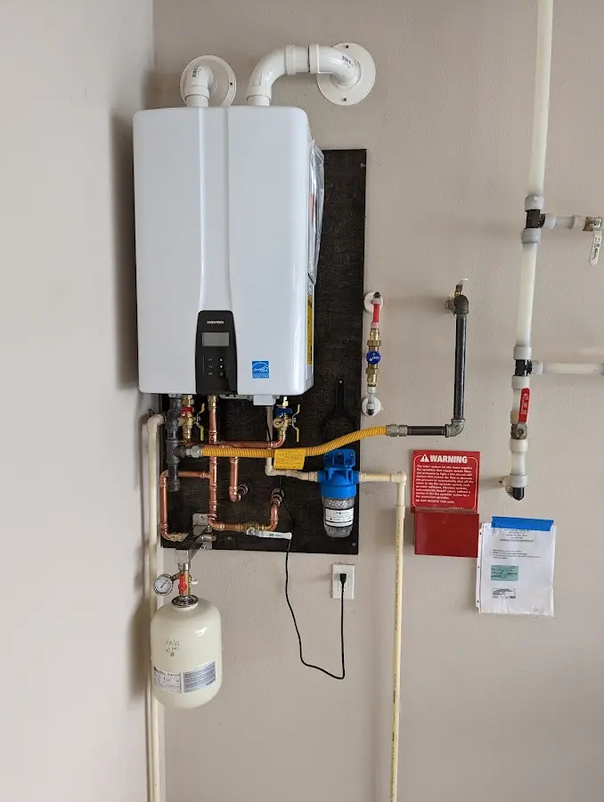Professional plumber installing copper piping in a Dixon Lane-MeadowCreek home